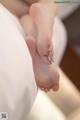 A close up of a person's feet on a bed.