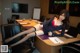 A woman sitting at a desk with a laptop computer.