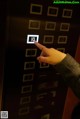 A person is pressing a button on an elevator.