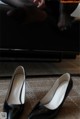 A pair of black shoes sitting on top of a carpeted floor.