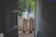 A couple of women standing next to each other on a balcony.