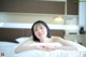 A woman laying on a bed in a hotel room.