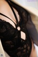 A close up of a woman wearing a black bra.