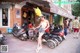 A woman standing in front of a row of parked motorcycles.