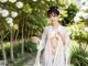 A woman in a white kimono posing for the camera.