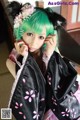 A woman with green hair wearing a black kimono.