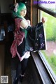 A woman in a kimono standing by a window.