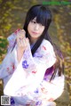 A woman in a kimono is posing for a picture.