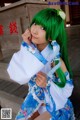 A woman with green hair wearing a blue and white kimono.