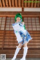 A woman in a blue and white outfit posing for a picture.