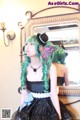 A woman with green hair wearing a black dress and a top hat.