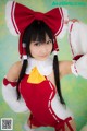 A woman in a red and white outfit posing for a picture.