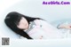 A woman in a bathtub with long black hair.