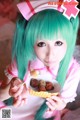 A woman with green hair holding a bowl of food.