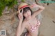 A woman in a red and white bikini and a straw hat.