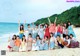 A group of young women posing for a picture on the beach.