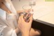 A woman sitting at a table holding a glass of water.