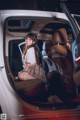 A woman sitting in the back seat of a car.