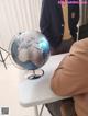 A man sitting at a table with a globe on it.