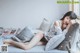 A woman laying on a bed with her head on a pillow.