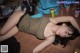 A woman laying on the floor next to cans of soda.