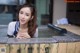 A woman leaning over the edge of a hot tub.