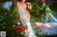 A woman in a white dress holding a basket of flowers.