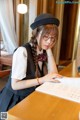 A woman sitting at a table reading a book.